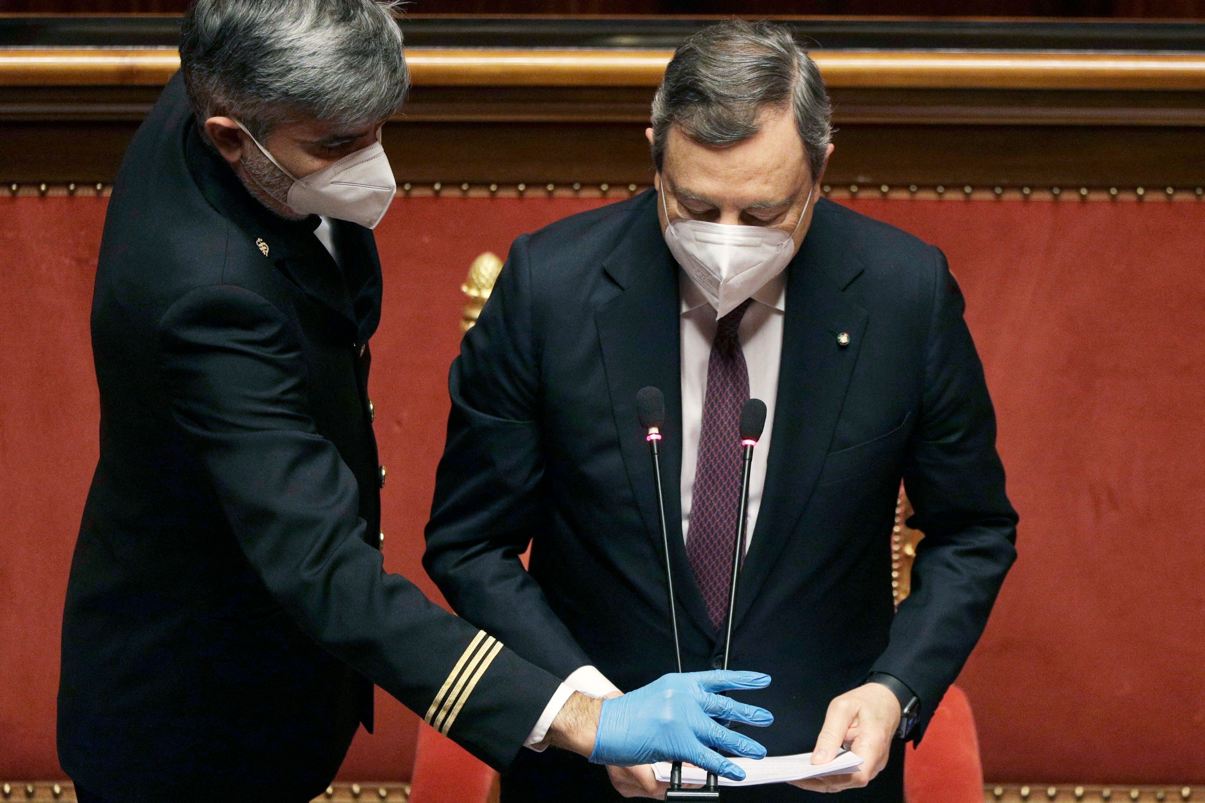 Italian Prime Minister Mario Draghi gets ready before addressing the Italian Senate to present the government's...