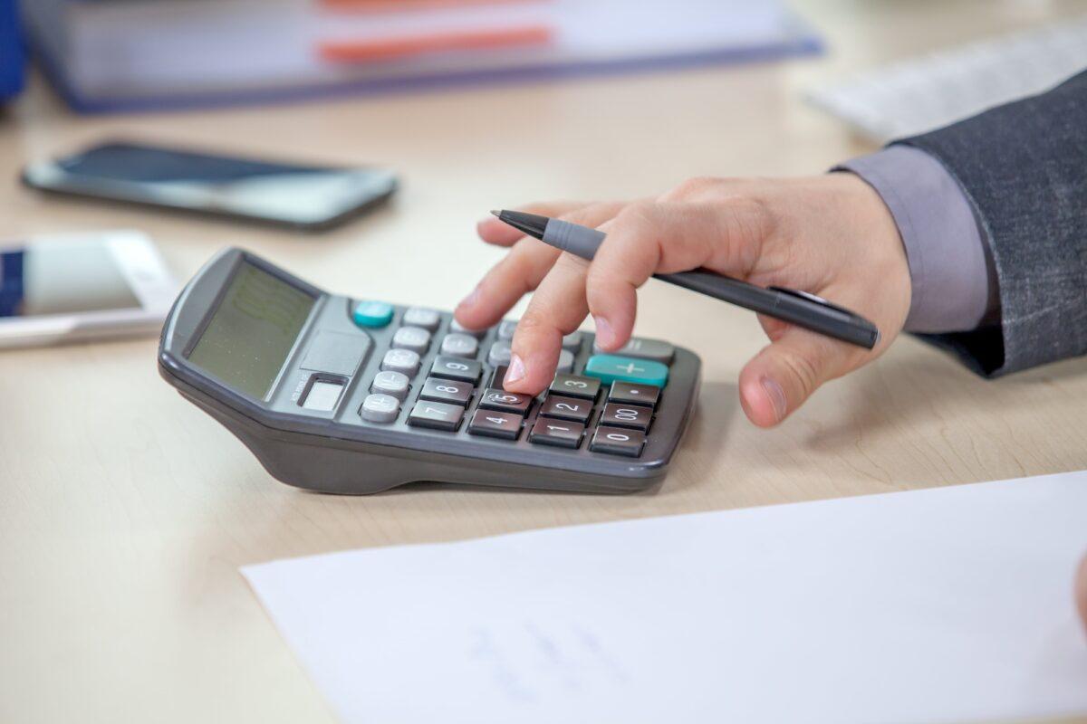 young-businessman-working-from-his-office-and-calculating-numbers-min