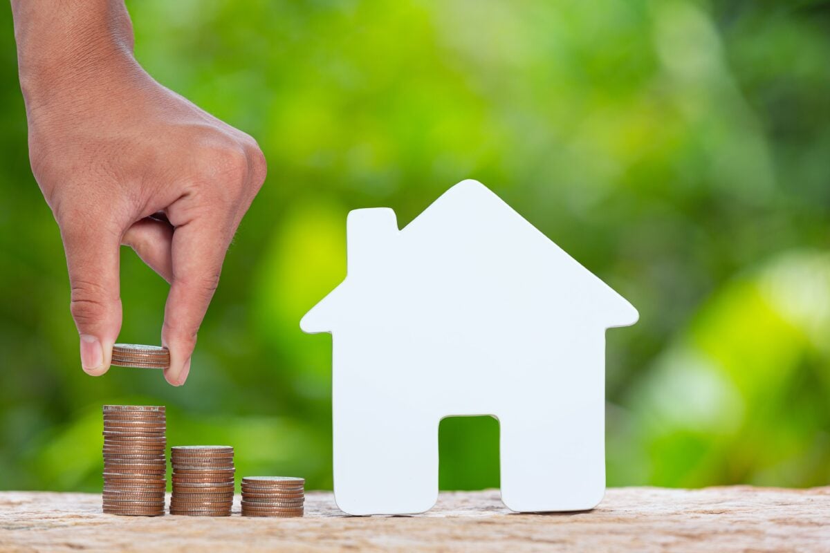 world-habitat-day-close-up-picture-of-a-pile-of-coins-and-a-model-house (1)-min